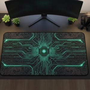 May include: A black rectangular gaming mouse pad with a circuit board design in shades of green and pink. The pad is on a black desk, with a curved monitor, desk lamps, and headphones in the background.