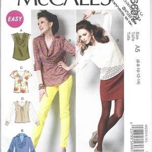 May include: McCall's sewing pattern showing different women's clothing designs. The pattern includes a cowl neck top, a plaid shirt, a floral top, a sweater top, and a denim shirt. The size range is A5 (6-8-10-12-14).