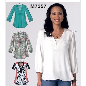 May include: McCall's M7357 sewing pattern for women's tops. The image shows a woman wearing a white blouse with long sleeves and a V-neck. The pattern includes different top styles, including a teal green top, a floral print top, and a black and white top with red accents.