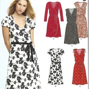 May include: A New Look sewing pattern featuring wrap dresses. The pattern includes various styles, such as a red long-sleeve dress, a black floral print dress, and a white dress with black floral print. The pattern size is A 8-18.