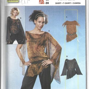 May include: A Burda sewing pattern for shirts, featuring three designs. The main image shows a woman in a brown, sheer top with wide sleeves and a black belt. Sizes range from 6/8 to 22/24.
