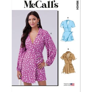 May include: McCall's sewing pattern M8454. The pattern features a woman wearing a pink romper with white spots. The pattern also shows illustrations of a blue romper and a tan romper. The words "Designed and printed in USA" are visible.