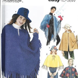 May include: Simplicity sewing pattern featuring various capes. The pattern includes a blue fringed cape, a blue fringed cape with a black top, a yellow cape, a tan cape, and a navy blue cape with floral embroidery. The pattern is labeled "easy-to-sew".