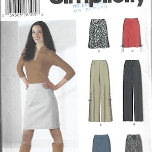 May include: Simplicity sewing pattern 5861 showing a woman in a white skirt with side lacing. The pattern includes designs for skirts and trousers. The word "Simplicity" is at the top.