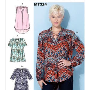 May include: A sewing pattern for four different tops. The pattern is called McCall's M7324. The tops are all different styles and colors. One top is pink, one is blue and green, one is blue and white, and one is red, blue, and white.