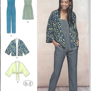 May include: Simplicity sewing pattern K8610 featuring a jumpsuit, dress, and jacket. The jacket has a blue and green abstract pattern. The jumpsuit is shown in a solid blue-grey fabric. The pattern includes sizes 6-14 and was established in 1927.