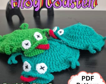 May include: Three handmade crochet frog coasters in shades of green and teal. Each coaster features white eyes with black cross details, a red mouth, and small legs. The image includes the text "Frog Coaster" and "Funny Frog".
