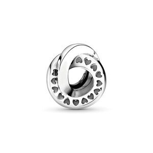 May include: A polished silver charm bead featuring an interlocking circular design. The outer surface of the metal band is decorated with a repeating pattern of small, recessed heart shapes that wrap around the entire circumference of the piece.