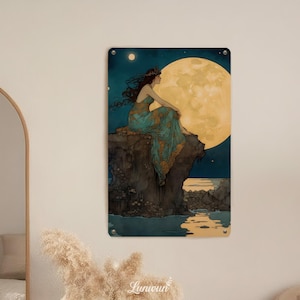 May include: Metal wall art featuring a woman in a teal dress with gold accents, seated on a cliff overlooking a moonlit sea. The artwork has a vintage aesthetic with a large yellow moon in the background. The piece is mounted on a wall.