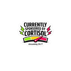May include: A white sticker with the text "CURRENTLY SPONSORED BY CORTISOL" in black, with a graphic of a meter and lightning bolts. The meter shows a needle pointing to the red zone, and the text "streaming 24/7" is below.