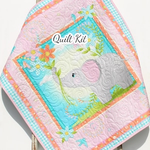 May include: A pink and blue baby quilt kit featuring a cute elephant with flowers and birds. The kit includes fabric for the quilt top, backing, and binding. The quilt is perfect for a baby shower gift or for a nursery.