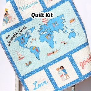 May include: A quilt kit featuring a world map with children playing on it. The kit includes fabric squares with the words "Welcome Here", "Our Wonderful World", "Love Buy First", and "Be the Good".