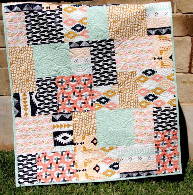 Fat quarter friendly quilt pattern with large-scale quilt blocks designed to showcase bold designer fabrics and novelty prints in a modern layout