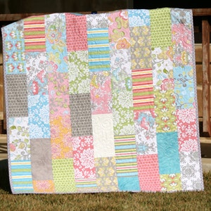 Instant download PDF quilt pattern featuring a modern patchwork quilt layout that beautifully showcases coordinated fabric collections and novelty prints