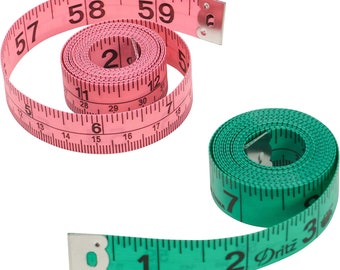May include: Two measuring tapes, one pink and one green, with black markings and metal end caps. The pink tape is rolled up and the green tape is partially unrolled. The green tape has the word "Dritz" printed on it.