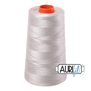 May include: A spool of silver grey thread with an orange top and the text "AURIfil" in blue.