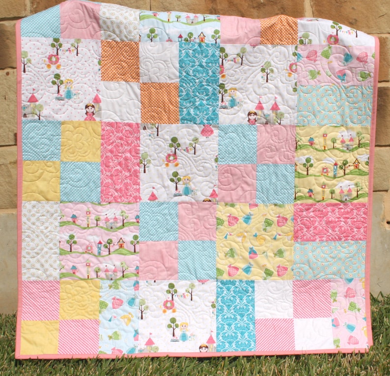 Easy PDF quilt pattern featuring a modern patchwork quilt layout with beginner friendly instructions and versatile sizing for baby quilts and throw quilts. The Whimsy Quilt Pattern by Kristin Blandford Designs works beautifully with layer cakes and coordinated fabric collections.