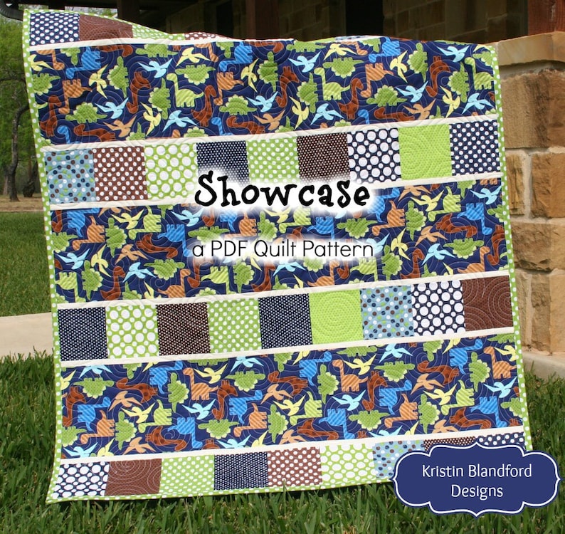 Modern nursery quilt pattern featuring dinosaur fabrics and colorful charm square patchwork for handmade baby shower gifts.