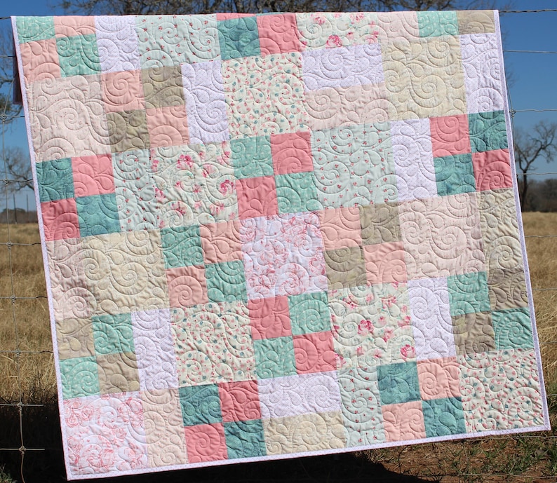 Whimsy Quilt Pattern digital download featuring a beginner friendly patchwork quilt layout with easy cutting and simple piecing designed for layer cakes and pre cut fabrics. This bestselling PDF quilt pattern is perfect for modern baby quilts, throw quilts, and cozy handmade gifts.