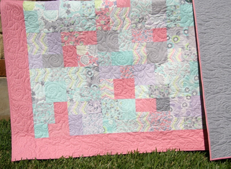 Modern patchwork quilt pattern designed for layer cake precuts with soft floral fabrics, vintage-inspired colors, and easy beginner quilt blocks