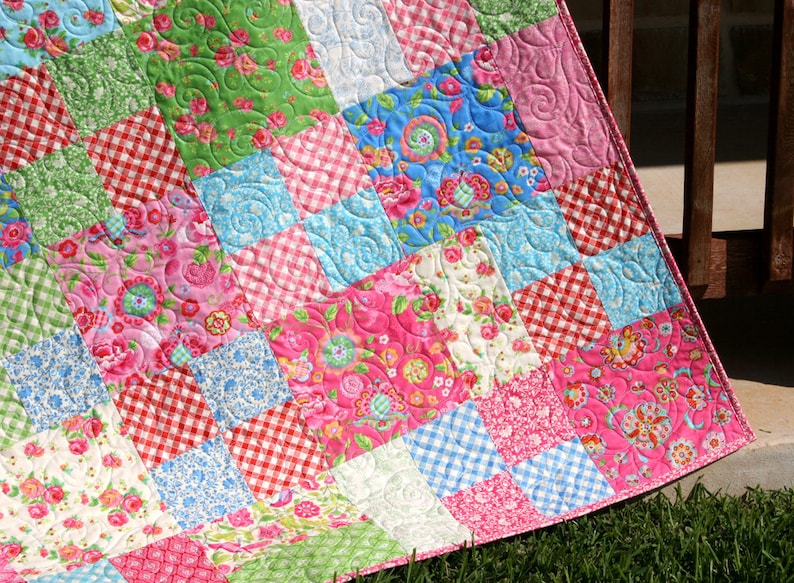 Modern Whimsy Quilt Pattern PDF featuring a classic patchwork quilt layout designed for 10 inch squares and pre cut fabric collections. This beginner friendly quilt pattern by Kristin Blandford Designs creates beautiful baby quilts and throw quilts with quick piecing and timeless style.