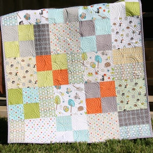 Easy layer cake quilt pattern featuring a bestselling patchwork design perfect for baby quilts, nursery quilts, and cozy lap throws. The Whimsy Quilt Pattern by Kristin Blandford Designs includes detailed instructions and easy to follow diagrams for beginner quilters and modern quilting projects.
