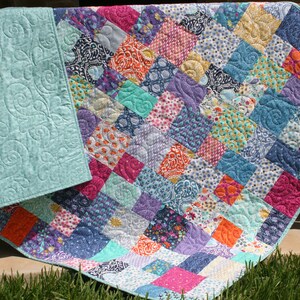 Layer cake friendly quilt pattern using 10 inch precut squares to create a fast and easy modern throw quilt with vintage charm