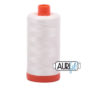 May include: A white spool of Aurifil thread with an orange plastic bobbin and the Aurifil logo on the side.