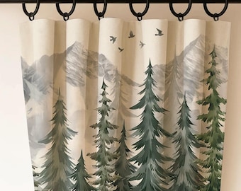 May include: Curtain panel with a forest scene. The design features green pine trees, gray mountains, and flying birds against a light beige background. The curtain is hung from a black rod with black rings.