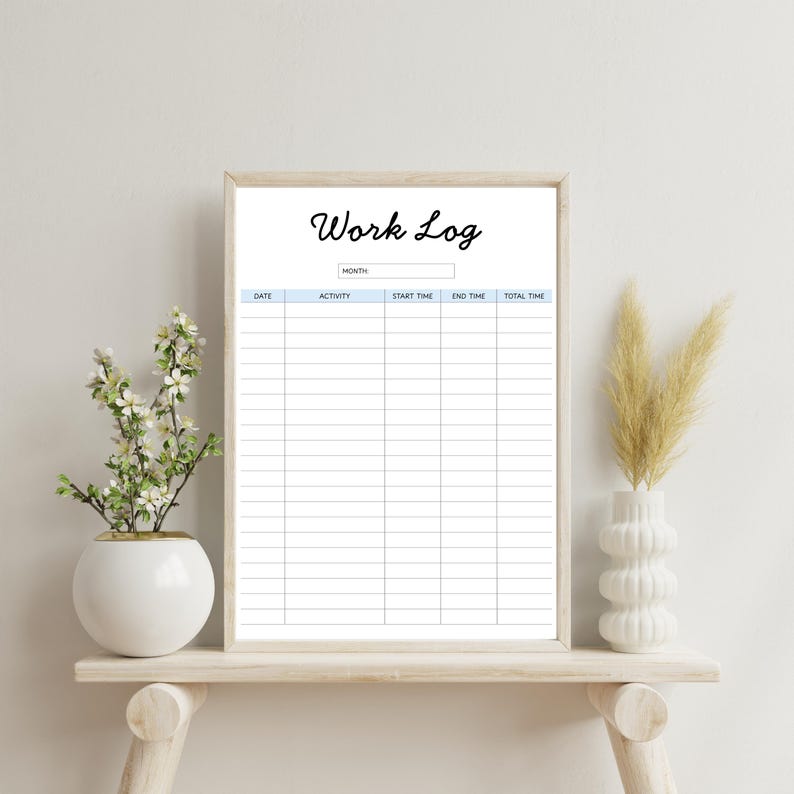 May include: A framed "Work Log" print with a light blue header and columns for date, activity, start and end times, and total time. The print is displayed on a light wooden shelf with decorative vases and plants.
