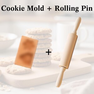 May include: A wooden rolling pin and a rectangular cookie mold are displayed on a wooden cutting board. The text "Cookie Mold + Rolling Pin" is at the top of the image. A stack of cookies is in the background.
