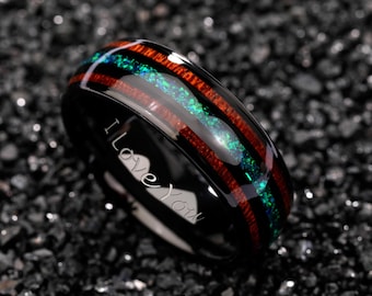 May include: Black ring with a wood grain and opal inlay. The ring has a red and green stripe design. The words "I Love You" are engraved on the side of the ring. This ring is a romantic gift.