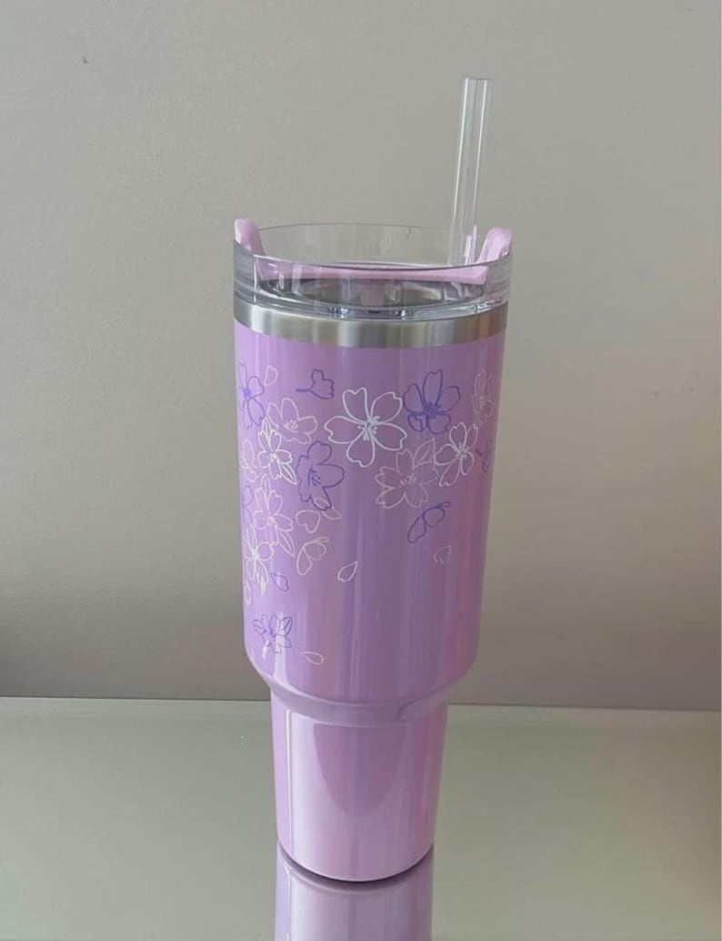 May include: A set of three ceramic mugs with a speckled, matte finish. The mugs are in shades of cream, light brown, and dark brown. Each mug has a simple, minimalist design and a rounded handle.