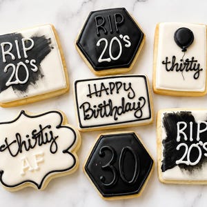 May include: A collection of seven decorated sugar cookies in black and white. Designs include text reading RIP 20's, thirty, Happy Birthday, and 30, along with a black balloon graphic. The cookies are square, hexagonal, and scalloped in shape.
