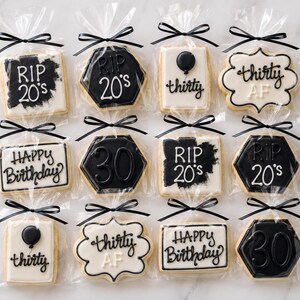 May include: Twelve individually wrapped sugar cookies decorated with black and white icing. Designs include text reading RIP 20's, thirty AF, Happy Birthday, and the number 30, along with balloon illustrations. Each cookie is tied with a black ribbon.