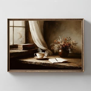 May include: A framed artwork depicts a cozy interior scene. A cup of tea sits on a saucer, steam rising, next to an open book. A vase of dried flowers and a stack of books are also on the wooden table. A window with a sheer curtain is in the background.