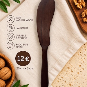 May include: A dark brown wooden butter spreader with a smooth, curved blade and a slender handle. The spreader measures 20 cm by 3 cm. Text on the image includes 100% NATURAL WOOD, HANDMADE, DURABLE & STRONG, and FOOD SAFE FINISH.