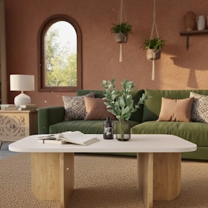 May include: A living room scene with a green sofa, a white coffee table with wooden legs, and a beige rug. Decorative pillows and plants add to the cozy atmosphere. A lamp and a bookshelf are also visible.