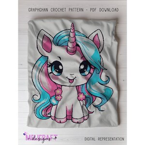 May include: A crochet pattern featuring a cartoon unicorn with a white body, pink and blue hair, and a blue horn. The unicorn has large, expressive eyes and is smiling. The text "GRAPHGHAN CROCHET PATTERN - PDF DOWNLOAD" is at the top.