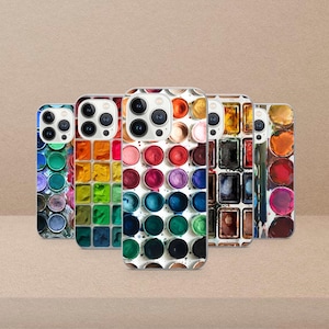 May include: Five phone cases showcasing watercolour paint designs. Each case displays a unique arrangement of colours, including blues, greens, reds, oranges, and yellows. The cases are set against a neutral backdrop, offering a vibrant display of artistic expression.