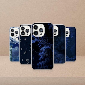 May include: A collection of five phone cases with various designs. The cases feature dark blue backgrounds with images of a lighthouse, stars, floral patterns, and abstract designs. The cases are arranged in a row, showcasing their unique artwork.