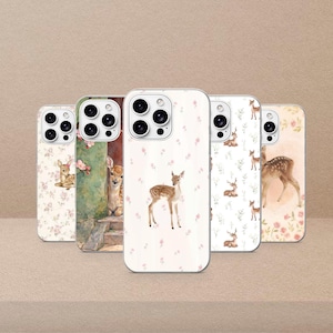 May include: Five phone cases with deer and floral designs. The cases feature illustrations of fawns and floral accents. The cases have a white background with pink flowers. The cases are designed for a mobile phone.