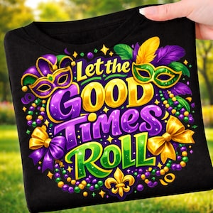 May include: Black t-shirt with a colorful Mardi Gras design. The graphic includes the text "Let the Good Times Roll" in gold, purple, and green, along with masks, beads, and a fleur-de-lis.