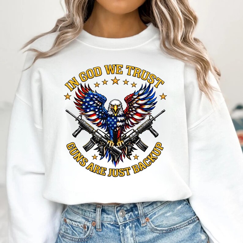 In God We Trust guns are just backup patriotic eagle design with American flag wings and crossed rifles on black background