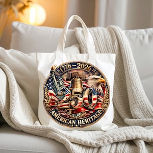 K&ouml;nnte beinhalten: Wei&szlig;e Tragetasche mit einem farbenfrohen, kreisf&ouml;rmigen Design, das das 250-j&auml;hrige Jubil&auml;um des amerikanischen Erbes feiert. Das Design zeigt die Freiheitsstatue, einen Adler, die Liberty Bell und die amerikanische Flagge. Der Text "1776-2026" und "250" sind prominent.