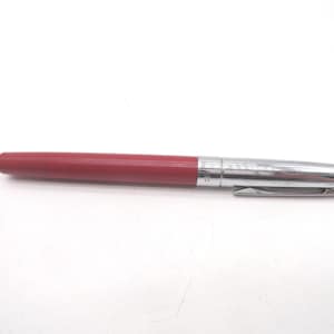 May include: A red pen with a silver-colored metal cap and clip. The pen's body is a solid, matte red, while the cap and clip have a shiny, reflective finish. The pen is lying horizontally against a white background.
