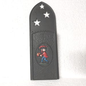 May include: Black metal wall mounted mail holder with a cutout of a boy holding a red bucket and three stars.