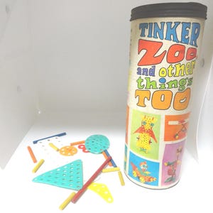 May include: A vintage Tinker Zoo and other things too toy set in a colorful cardboard tube. The tube has illustrations of animals and other creations that can be made with the toy. The set includes colorful plastic pieces and rods.
