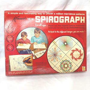 May include: Vintage Kenner's New Spirograph set in a red box. The box features illustrations of children drawing patterns and examples of Spirograph designs. Text on the box reads, "A simple and fascinating way to DRAW a million marvelous patterns."