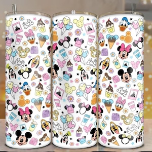 May include: Three white stainless steel tumblers with a colorful pattern of Disney characters and icons. The design includes Mickey and Minnie Mouse, Donald Duck, ice cream cones, and other themed elements. Each tumbler has a silver straw.